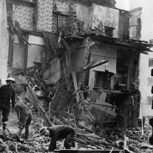 Air Raid Precautions workers salvaging in the debris of two working class houses bombed Air Raid Precautions workers salvaging in the debris of two working class houses bombed