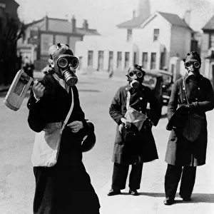 Air Raid Warden sounds her gas rattle in Kingston upon Thames during a gas alarm
