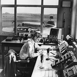 Air traffic controller Mr Gordon Faulkner records the arrival of a viscount aircraft
