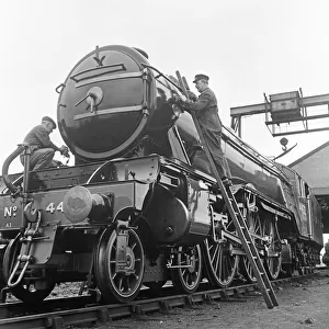 Alan Pegler, (right on his ladder), cleans and polishes The Flying Scotsman