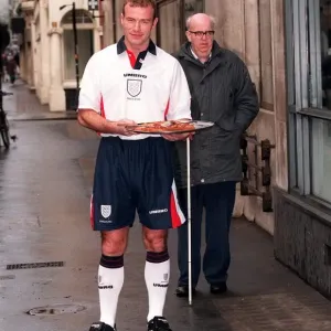 ALAN SHEARER MODELLING THE NEW 1997 ENGLAND HOME STRIP AND HOLDING A