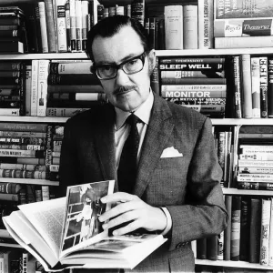 Alan Whicker TV presenter in his library in his flat May 1968 in Regents Park