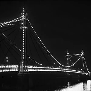 The Albert bridge illuminated at night in London 1951