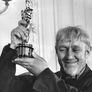 Alec Guinness receiving his Oscar for Best Actor in The Bridge on the River Kwai at