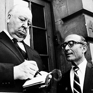 Alfred Hitchcock Film Director signs an autograph during a break from filming in Covent