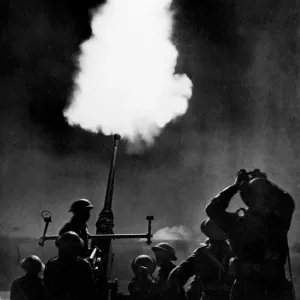 Allied forces operating a 40mm Bofors anti-aircraft gun battery in the final drive
