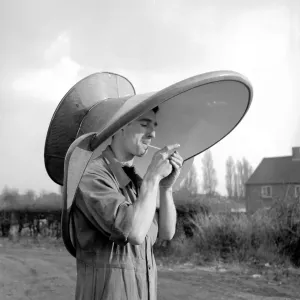 An alternative use for a hip bath. This workmen is using it as a hat An alternative use for a hip bath. This workmen is using it as a hat