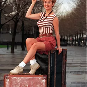 Amanda Reddington actress sitting on suitcase