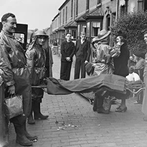 Ambulance men, ARP wardens and members of the public taking part in a air raid exercise