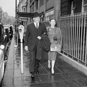 American actor Clark Gable with his wife walking through a London street with his wife