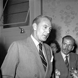 American actor Gary Cooper talking to people upon his arrival in England