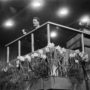 American evangelist Billy Graham addressing a huge crowd of people at Kelvin Hall in American evangelist Billy Graham addressing a huge crowd of people at Kelvin Hall in