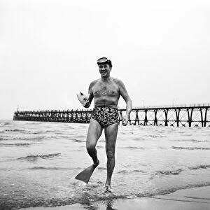 American film actor Sonny Tufts peparing to take the water at Blackpool in search of fish