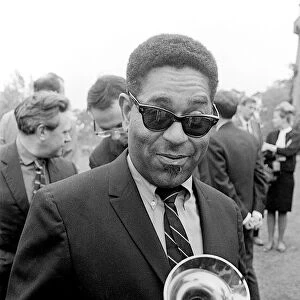 American jazz musician Dizzy Gillespie holding his trumpet at Fort Belvedere near Ascot