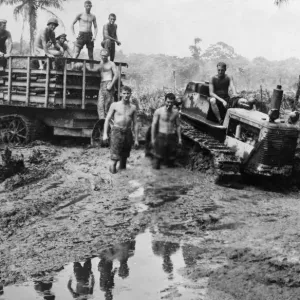 American marines with a caterpillar tractor and trailer move ahead through a sea of mud American marines with a caterpillar tractor and trailer move ahead through a sea of mud