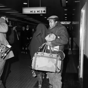 American pop artist Prince leaving Britain with a blanket over his head
