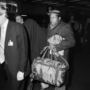 American pop artist Prince leaving Britain with a blanket over his head