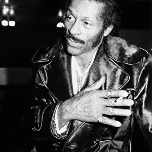 American rock n roll singer Chuck Berry smoking a cigarette after a concert
