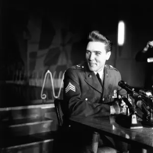 American rock and roll singer and musician Elvis Presley pictured wearing army uniform as