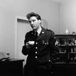 American rock and roll singer and musician Elvis Presley pictured wearing army uniform