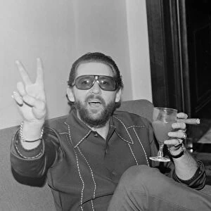 American rock and roll singer and musician Jerry Lee Lewis relaxing in his hotel suite in