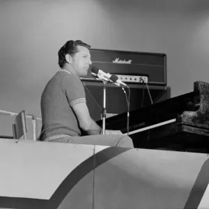 American rock and roll singer and musician Jerry Lee Lewis performing on stage at a rock