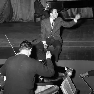 American singer and film star Frank Sinatra sitting on stage during rehearsals American singer and film star Frank Sinatra sitting on stage during rehearsals