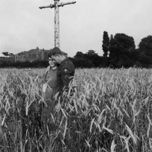 An American soldier and his girlfriend take a stroll through a field of barley near An American soldier and his girlfriend take a stroll through a field of barley near