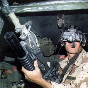 An American soldier looking through a night vision scope