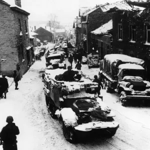 American troops pass through snow-covered street in Lierheux Belgium during WW2