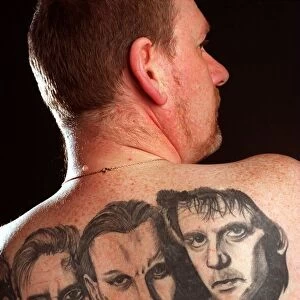 Andy Drummond who has the group Runrig tattoo-ed on his back. May 1997