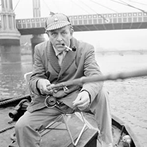 An angler from the Soho Firestation seen here fishing off a barge moored close to