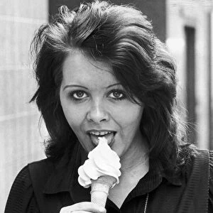 Anne Alexander gives a suggestive lick to a creamy ice cream cone. 15th May 1980