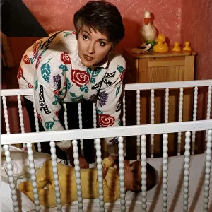 Anne Diamond TV Presenter Putting baby in to cot