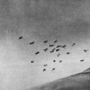 Anti-aircraft shells burst over Southern England trying to repel another air raid by