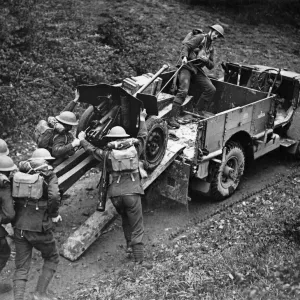 Anti tank gun being unloaded from a transport truck at the double to ready for action Anti tank gun being unloaded from a transport truck at the double to ready for action