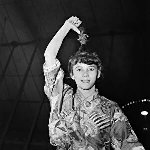 Anzti Loops her hair to go on hook in circus act. November 1952 C5390-001