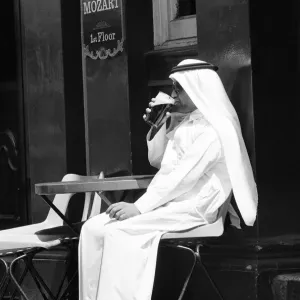 Arab man sitting outside enjoying a pint of Guinness at the Stanhope public house Arab man sitting outside enjoying a pint of Guinness at the Stanhope public house