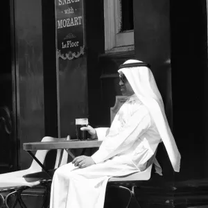 Arab man sitting outside enjoying a pint of Guinness at the Stanhope public house Arab man sitting outside enjoying a pint of Guinness at the Stanhope public house