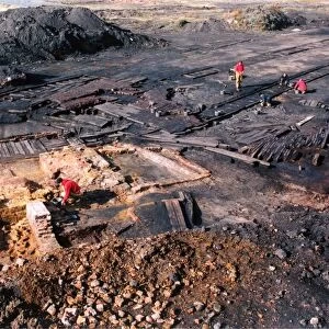 Archaeologists digging up a perfectly preserved wooden railway which had lain buried
