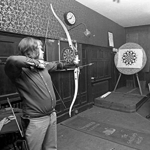 Archers challenge darts players to a game of darts, with the Archers using their bows