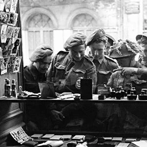 Army Soldiers looking through a shop window - June 1944 for souvenirs to send back home