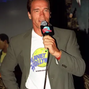 Arnold Schwarzenger Actor July 98 At Planet Hollywood restaurant in london holding
