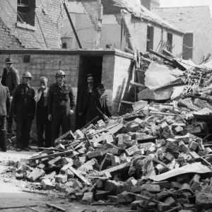 ARP personnel, Air raid warden help to search for survivors in an East Hull street after