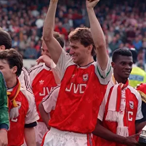 Arsenal captain Tony Adams lifts the League Championship trophy after they defeated