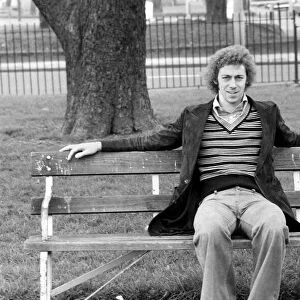 Arsenal footballer Charlie George sitting on a bench at Hackney marshes February