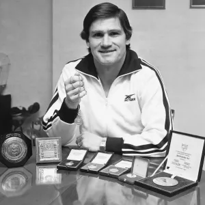 Arsenal footballer Pat Rice shows off his trophies, February 1983