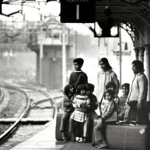 Asian immigrant family waiting at Bishops Stortford train station Print Asian immigrant family waiting at Bishops Stortford train station Print