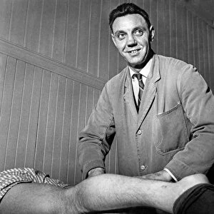 Assistant trainer Joe Fagan massages the legs of Peter Thompson in the medical room at