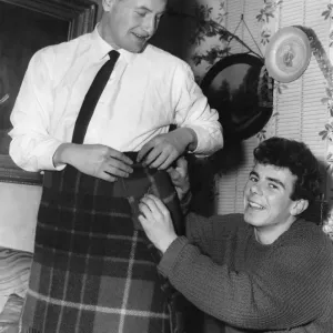 Aston Villa footballer Charlie Aitkens tries out a kilt. 30th December 1961 Aston Villa footballer Charlie Aitkens tries out a kilt. 30th December 1961